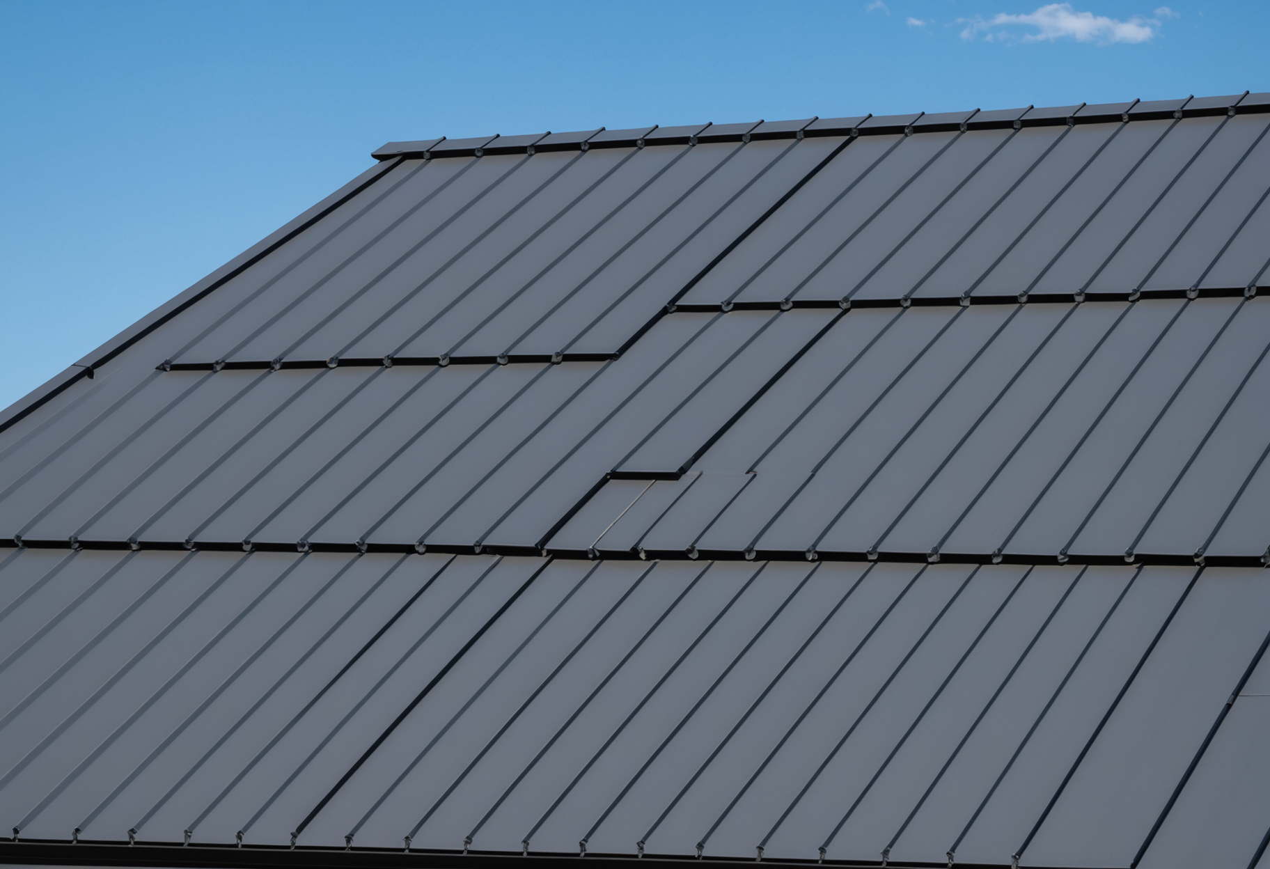 Standing seam metal roof panels with clean geometric lines on a residential structure